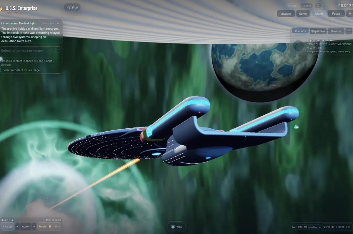 The Enterprise at rest in a green nebula, an orange beam lancing out beneath the saucer, a blue and grey moon above.