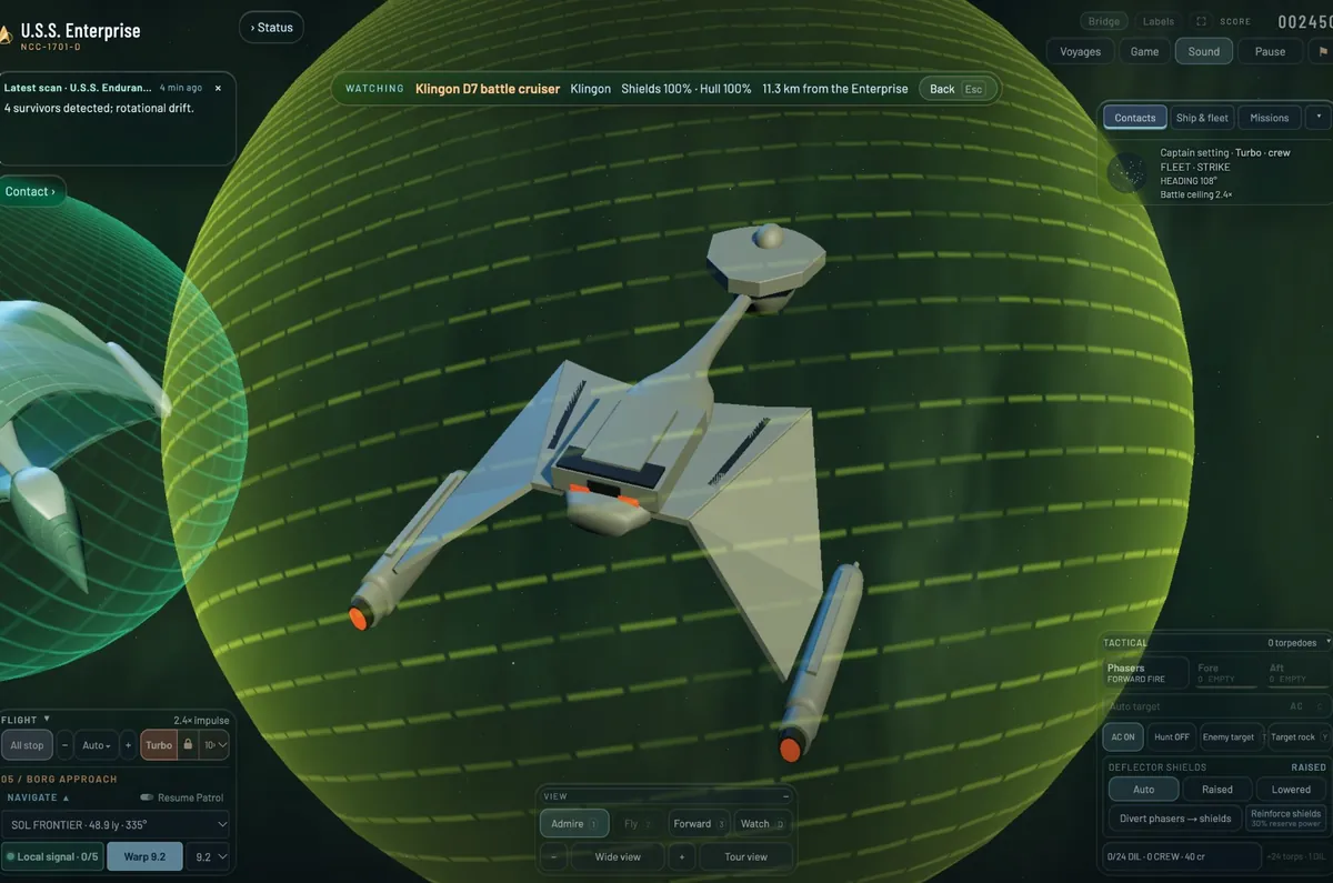 A Klingon D7 battle cruiser from below inside its green shield bubble, warp nacelles glowing orange at the back.