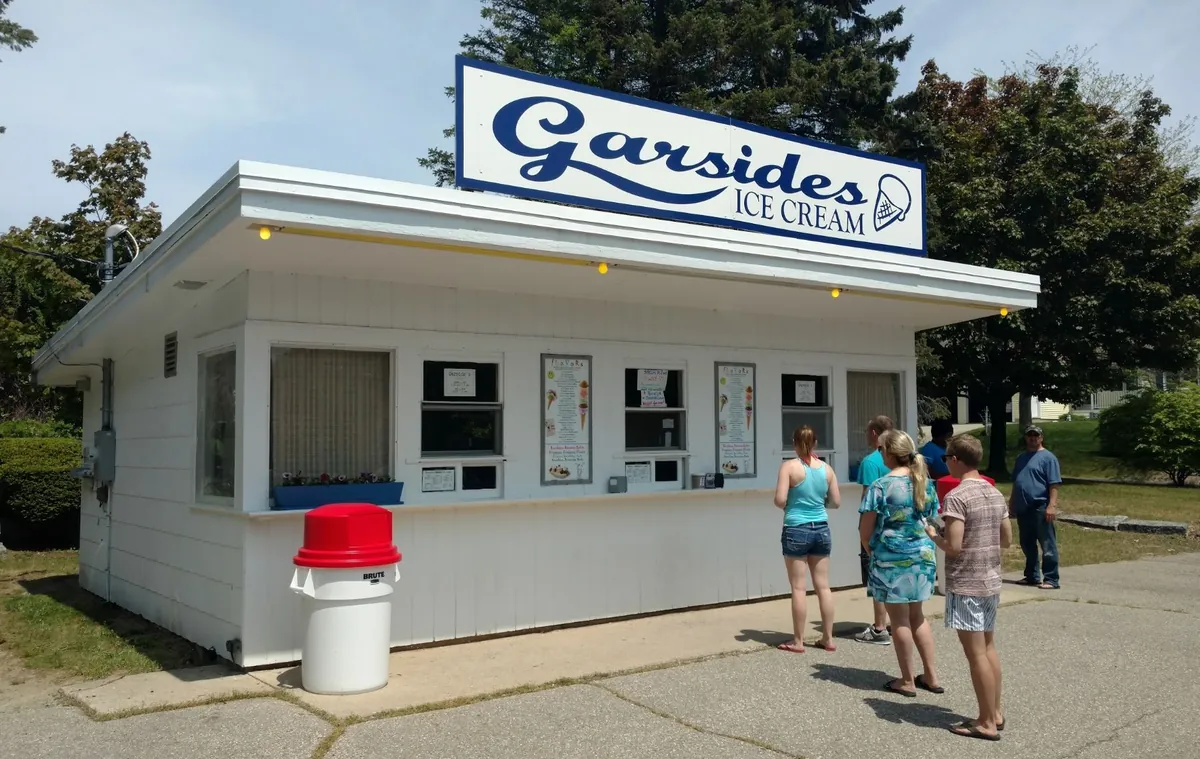 Garside's from the side on a sunny day, a few customers lined up at the windows.