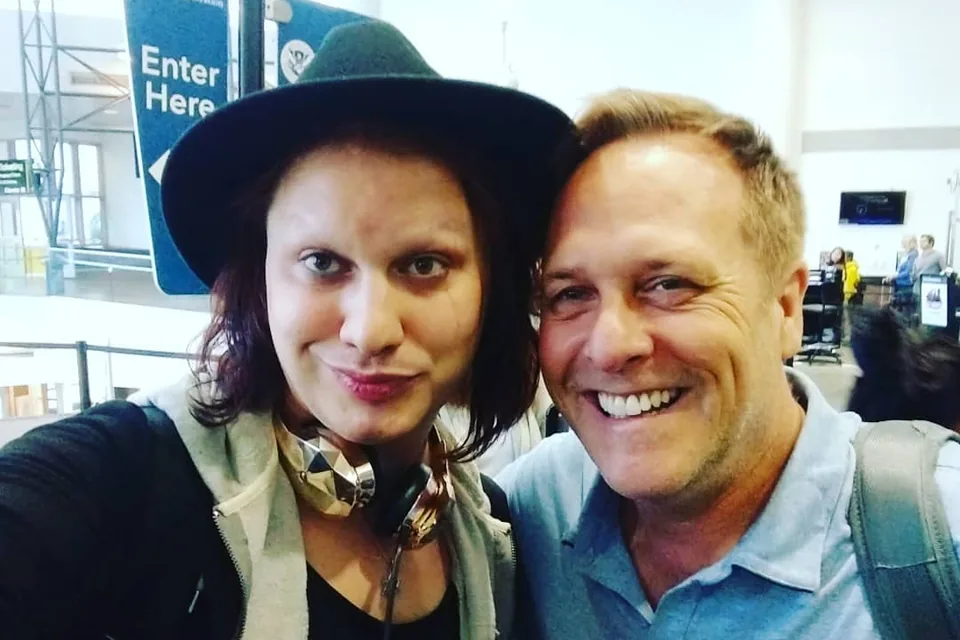Eric in a grinning airport selfie with the drag performer Jinkx Monsoon in 2018.