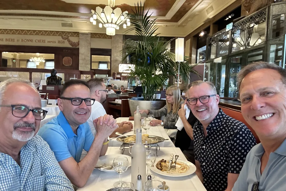 Friends at a restaurant table in Lyon in 2024.